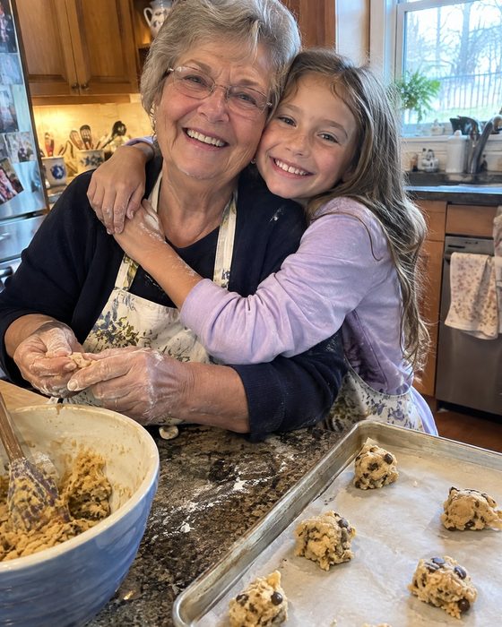 Polaroid of a grandmother and granddaughter hugging while baking cookies — the photo behind the sample song 'Flour on Our Hands'