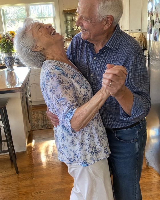 Polaroid of an older couple laughing as they slow-dance in their kitchen — the photo behind the sample song 'Kitchen Light Waltz'